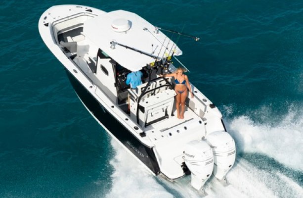 Young couple on a dual motor fishing boat